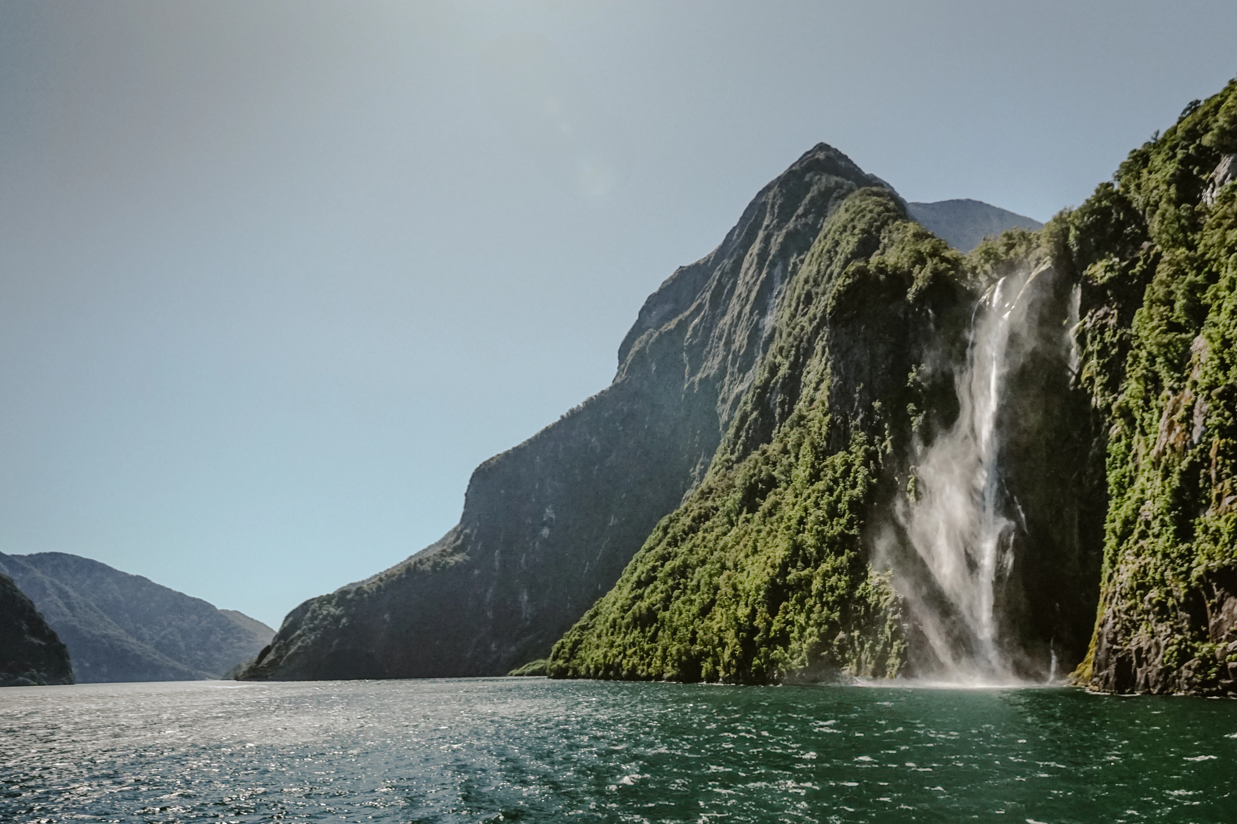 A waterfall in the middle of a body of water