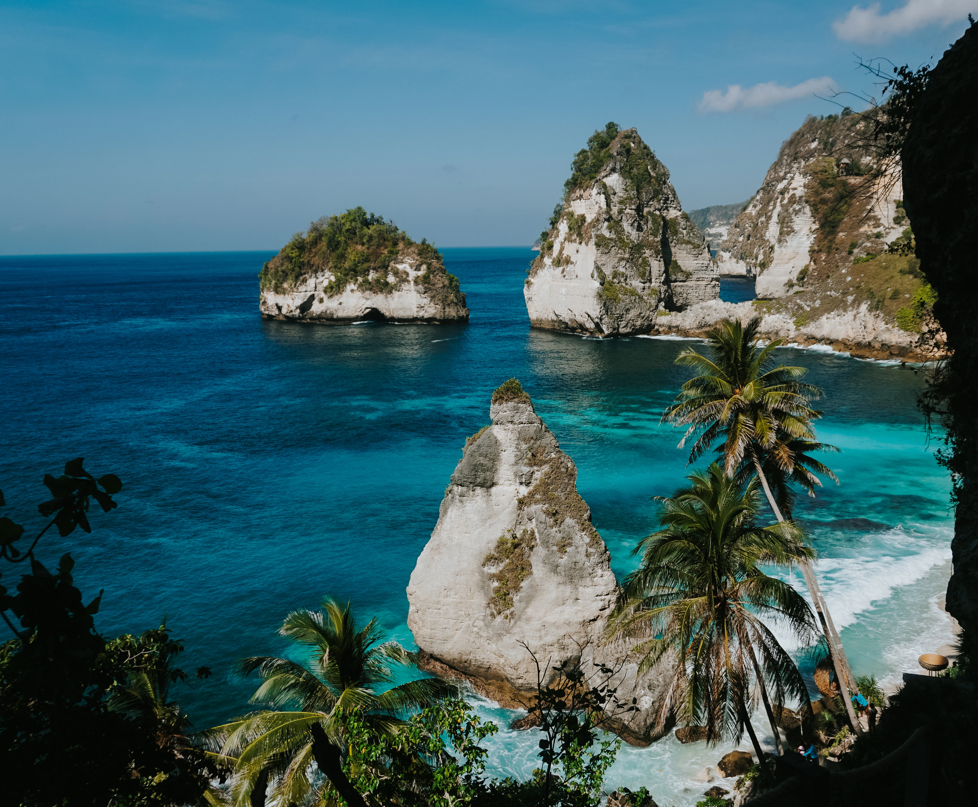 Tropical island cliffs with clear blue ocean water