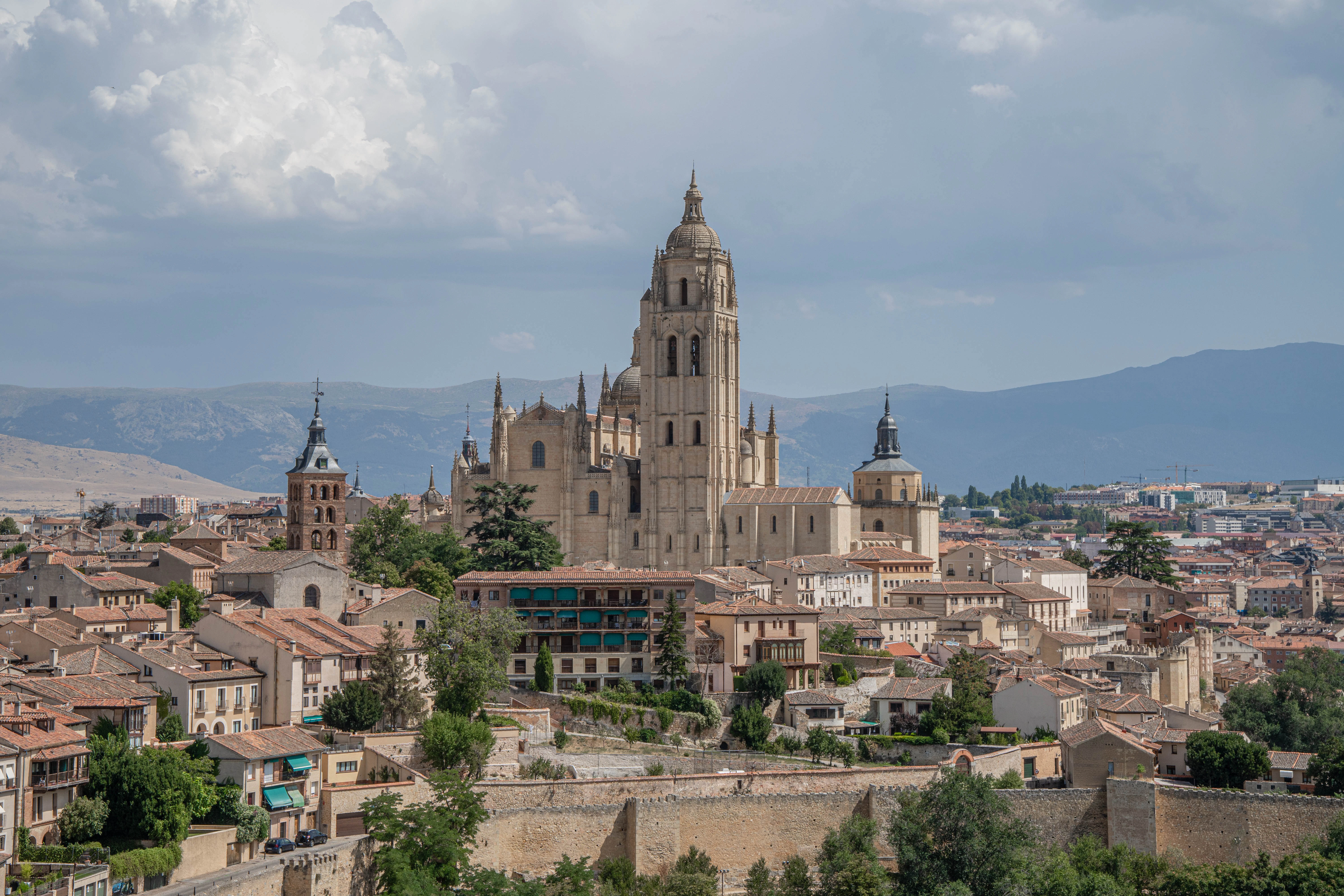 a large cathedral towering over a city filled with tall buildings