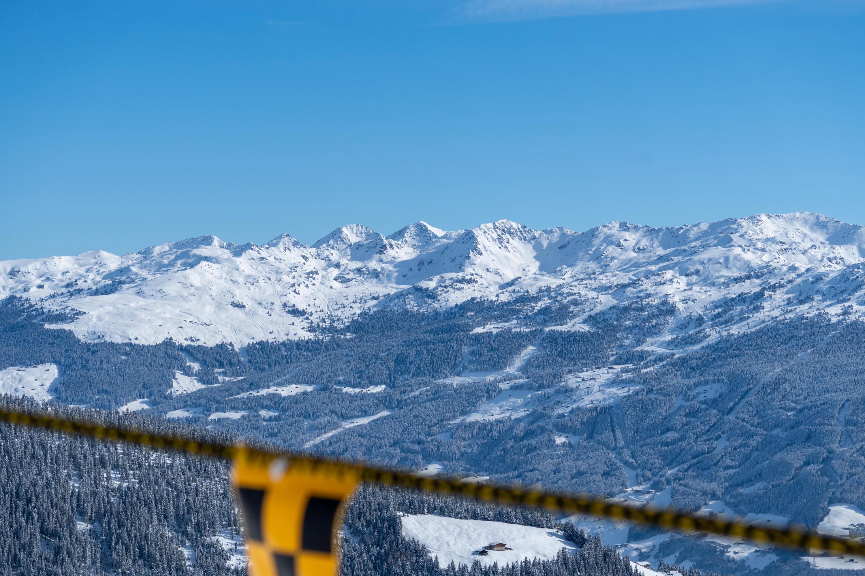 a view of a snowy mountain range from a ski lift