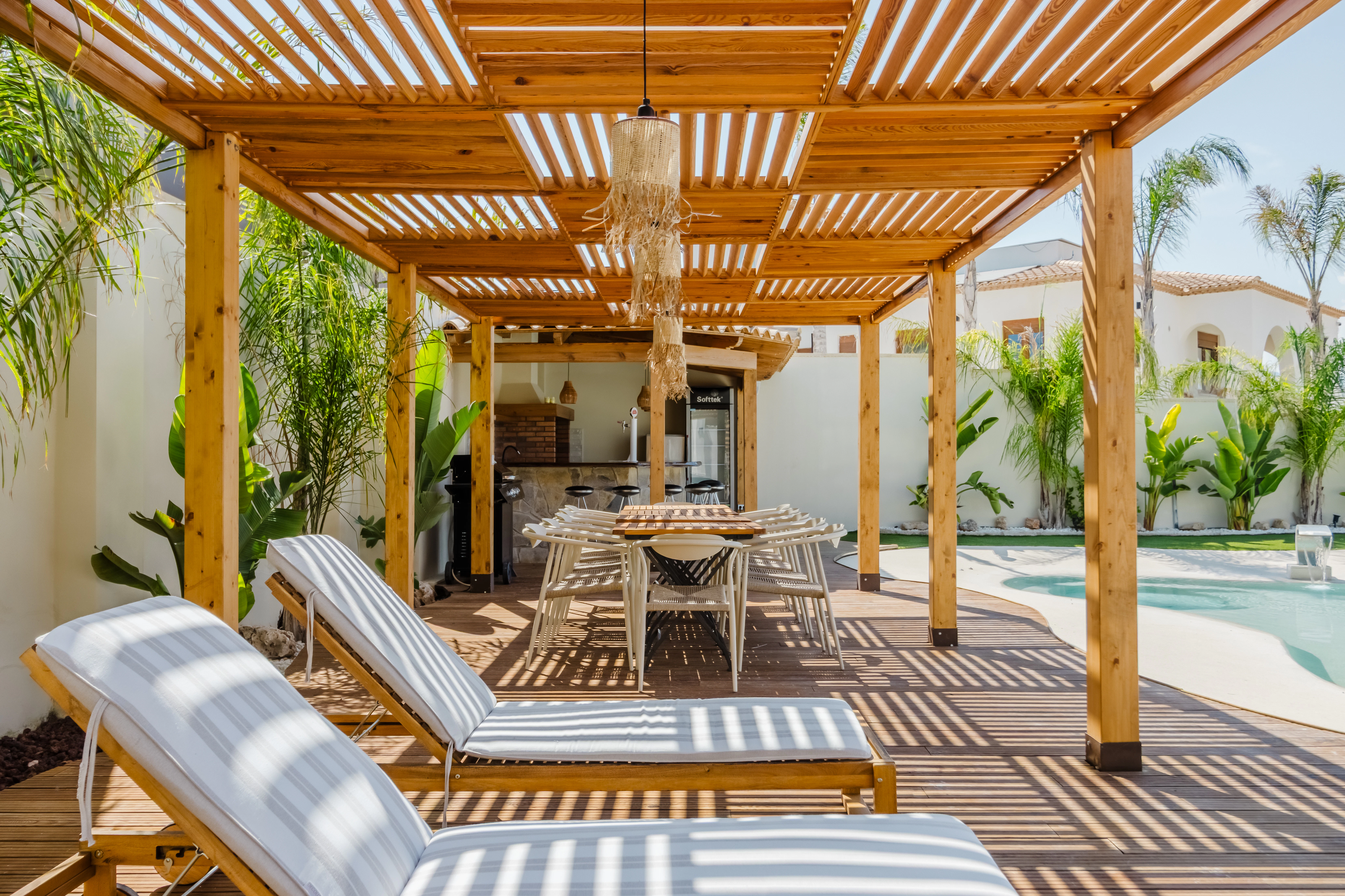 Outdoor patio with lounge chairs and dining table.
