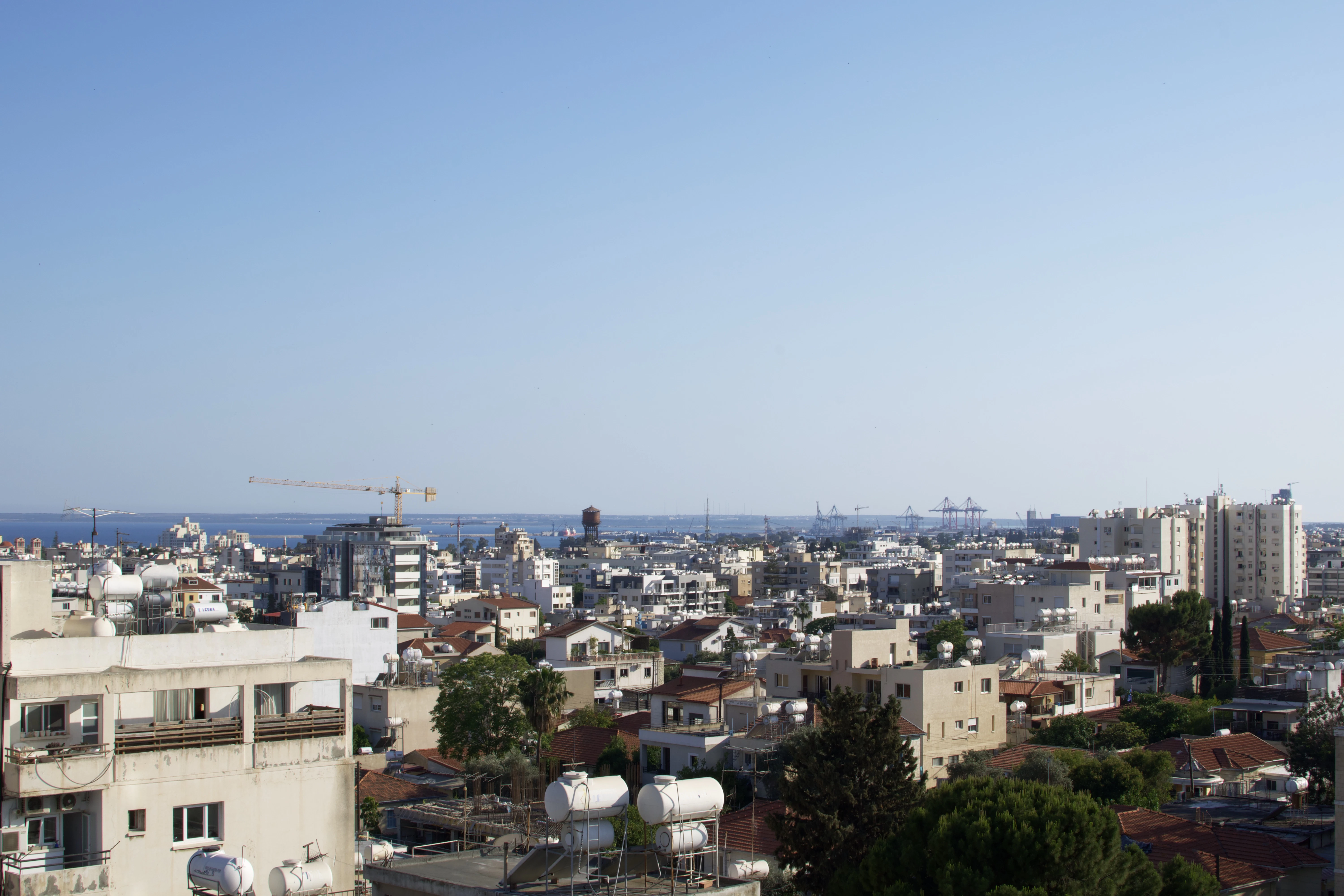 a city with a body of water in the background