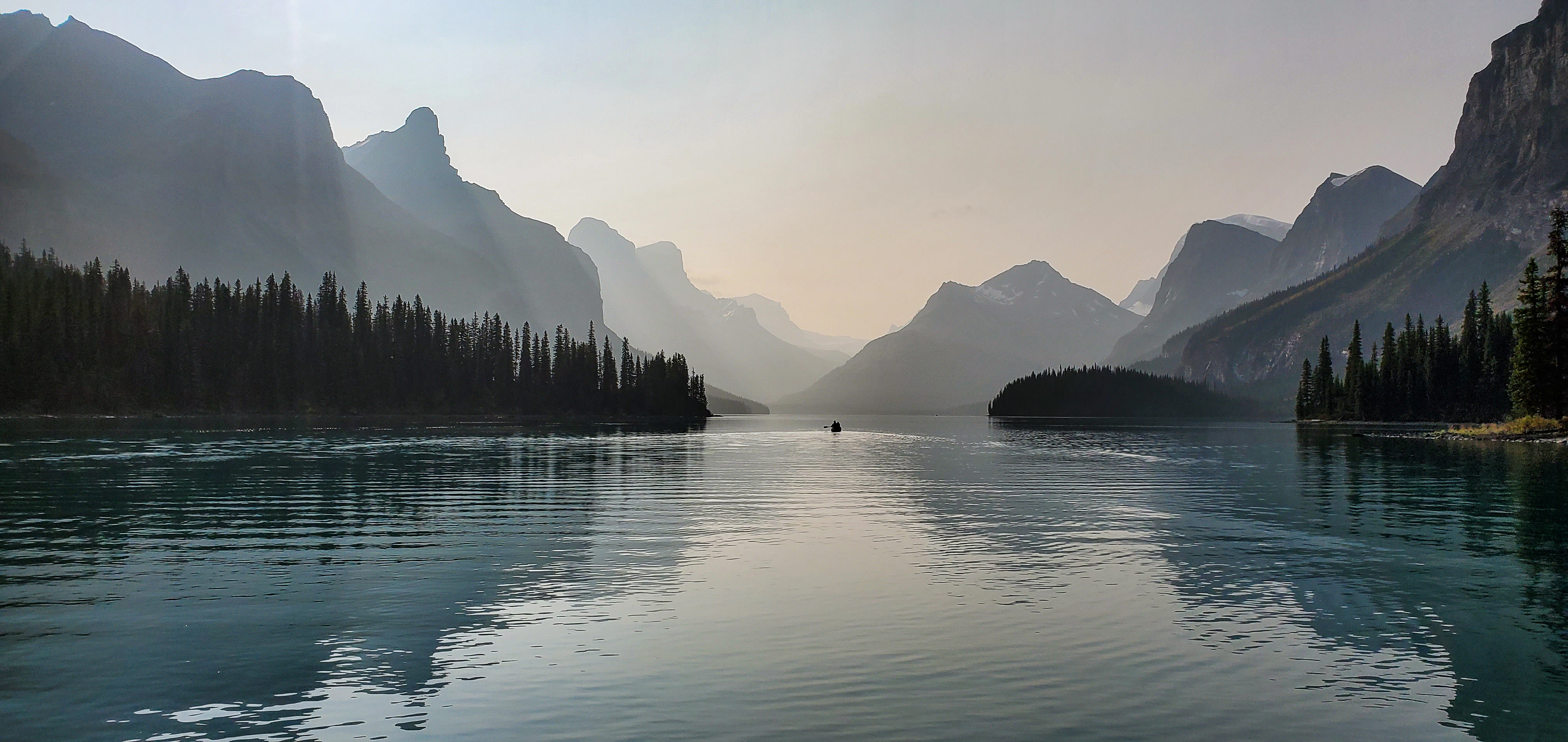 body of water near mountain during daytime