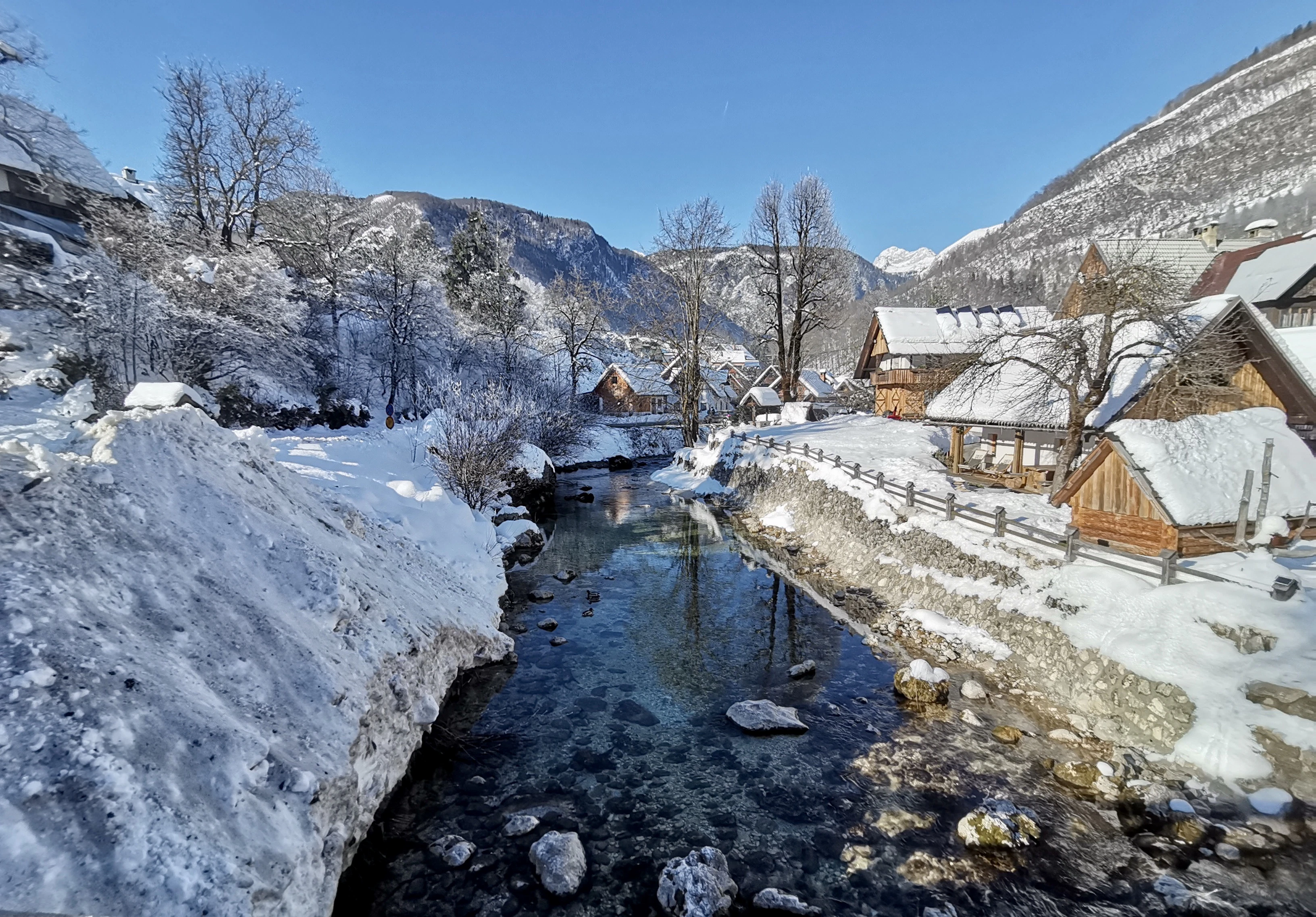 a river running through a snow covered hillside