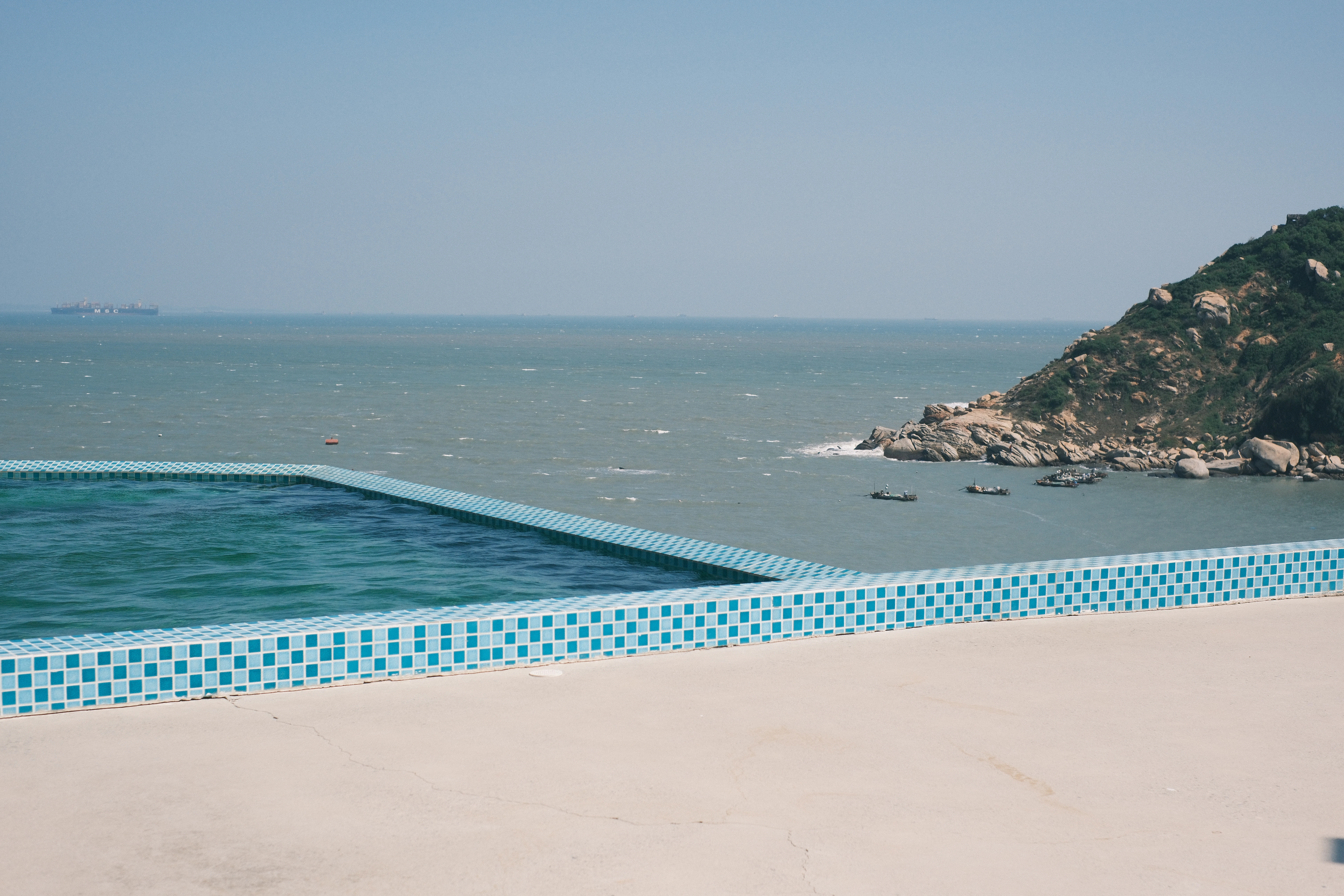 Infinity pool overlooking the ocean and rocky coast