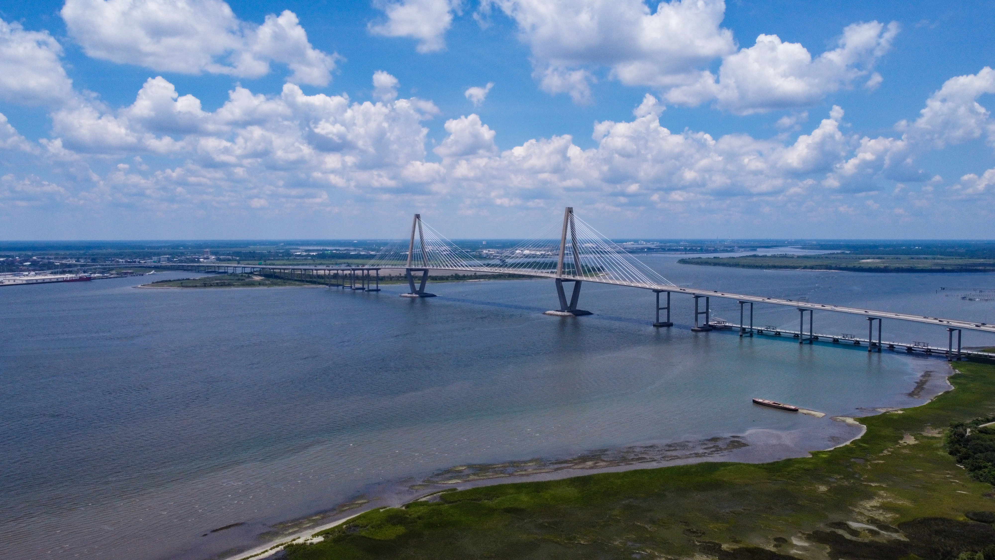 A long cable-stayed bridge spans a wide body of water.