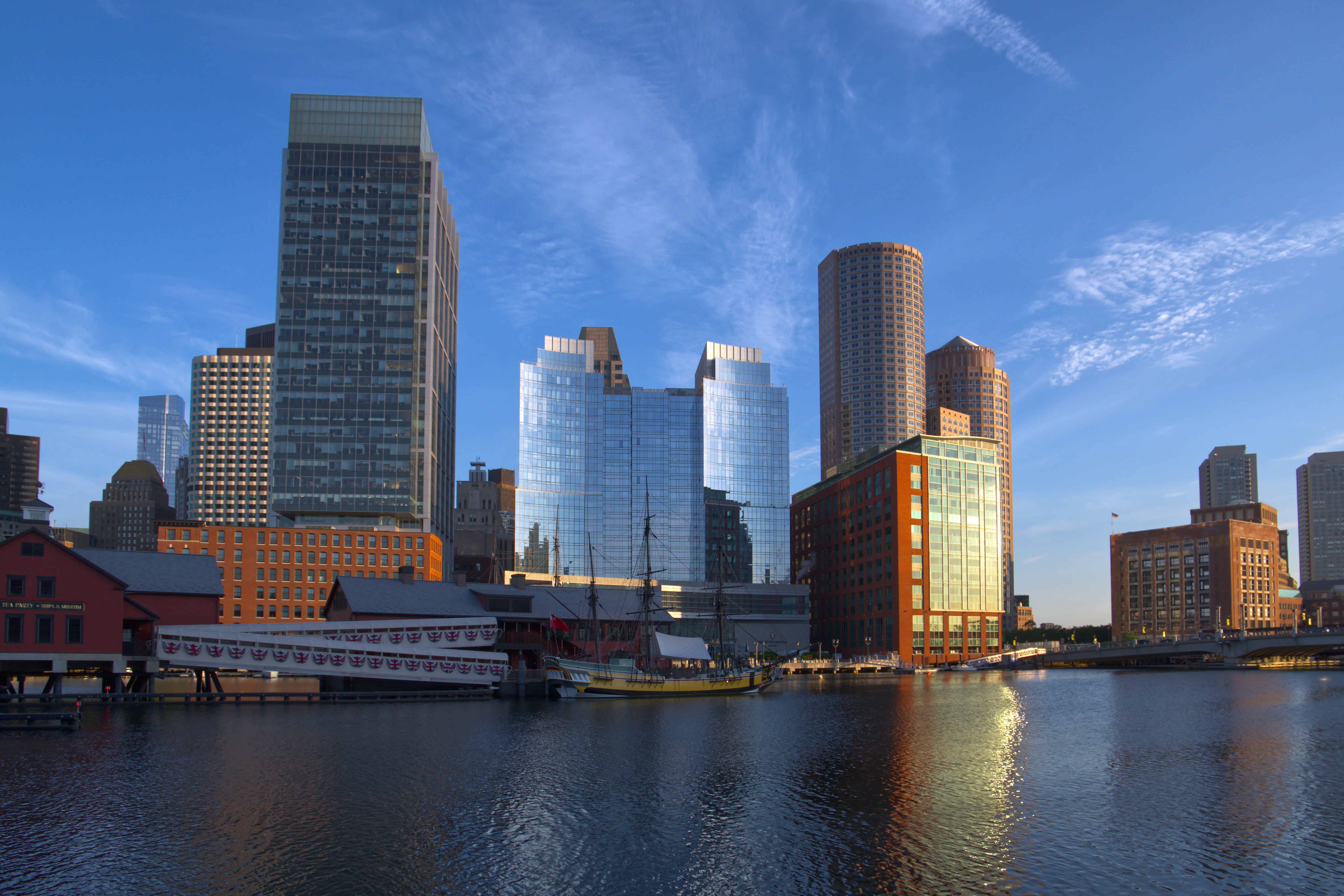 Modern skyscrapers and historic buildings by the water.
