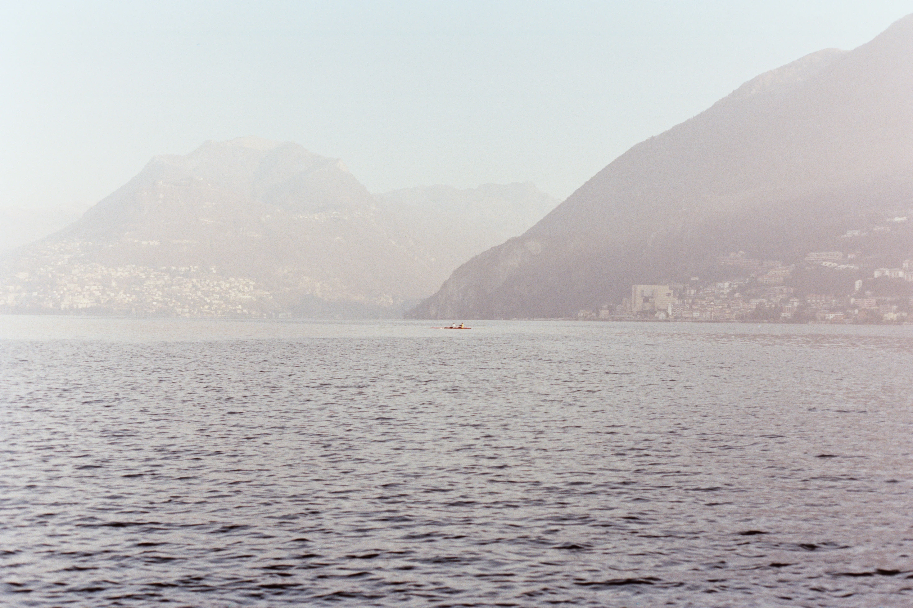 a body of water with mountains in the background