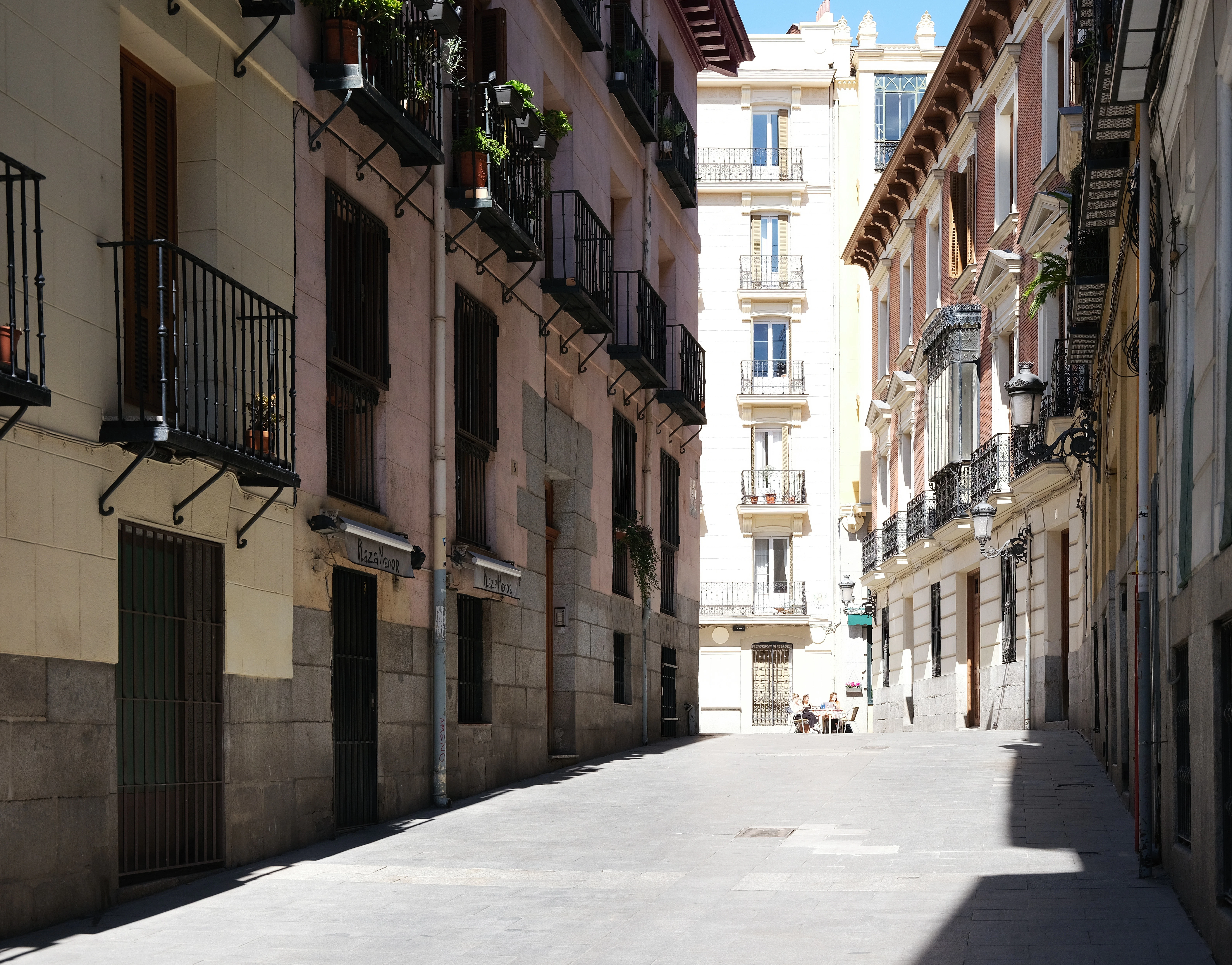 a narrow city street lined with tall buildings