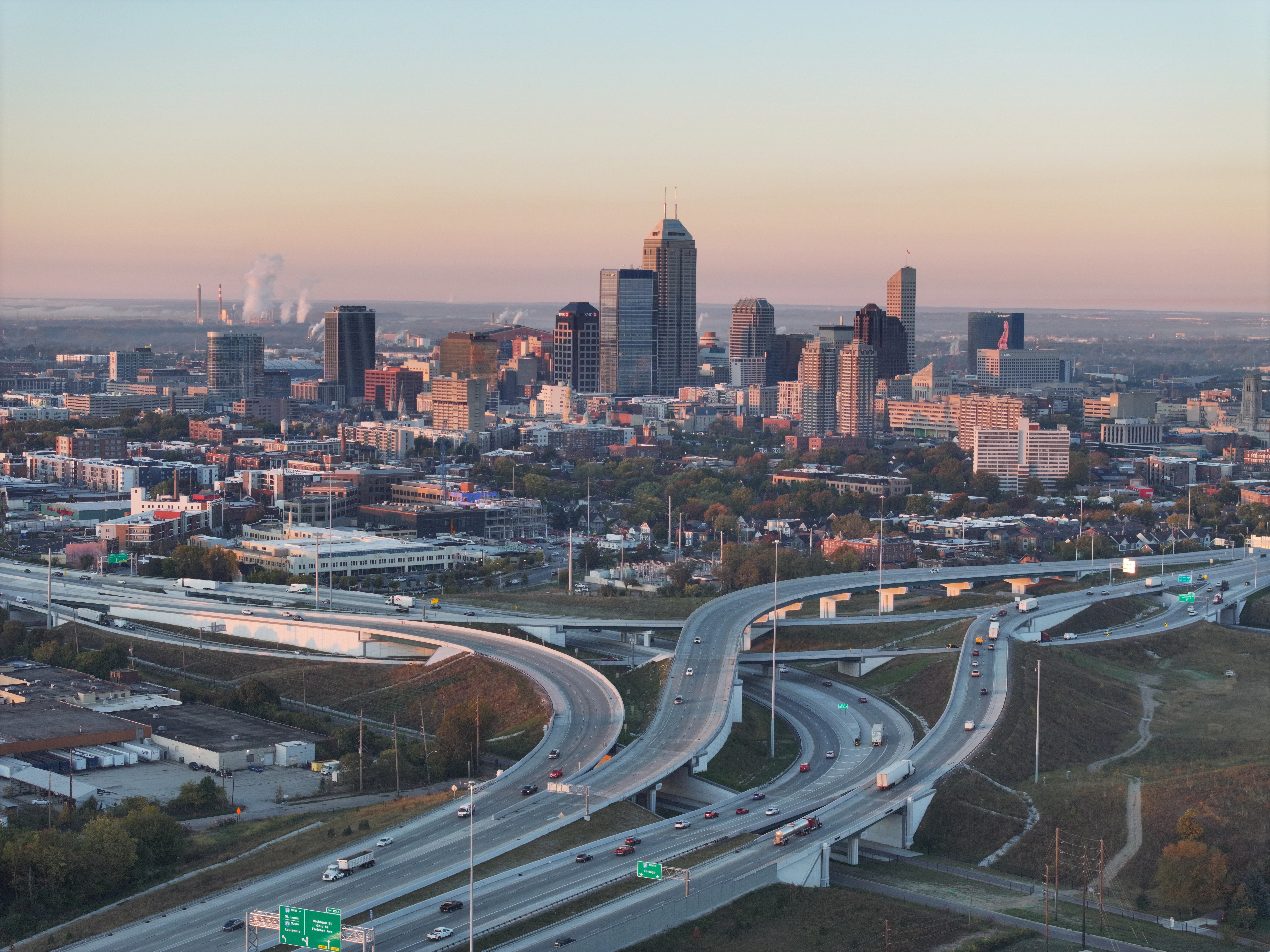 An aerial view of a highway with a city in the background