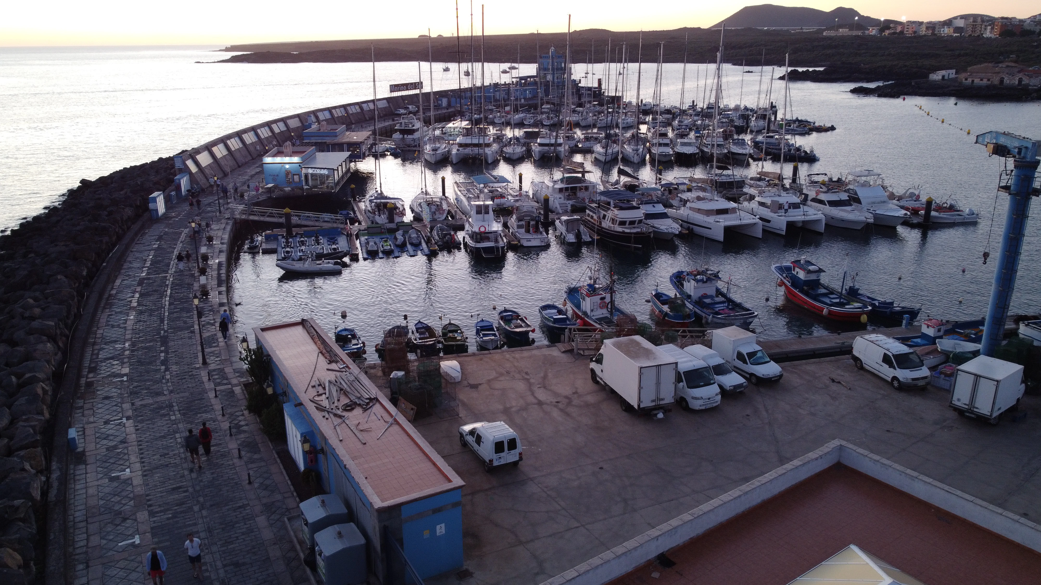 a harbor filled with lots of boats next to a bridge