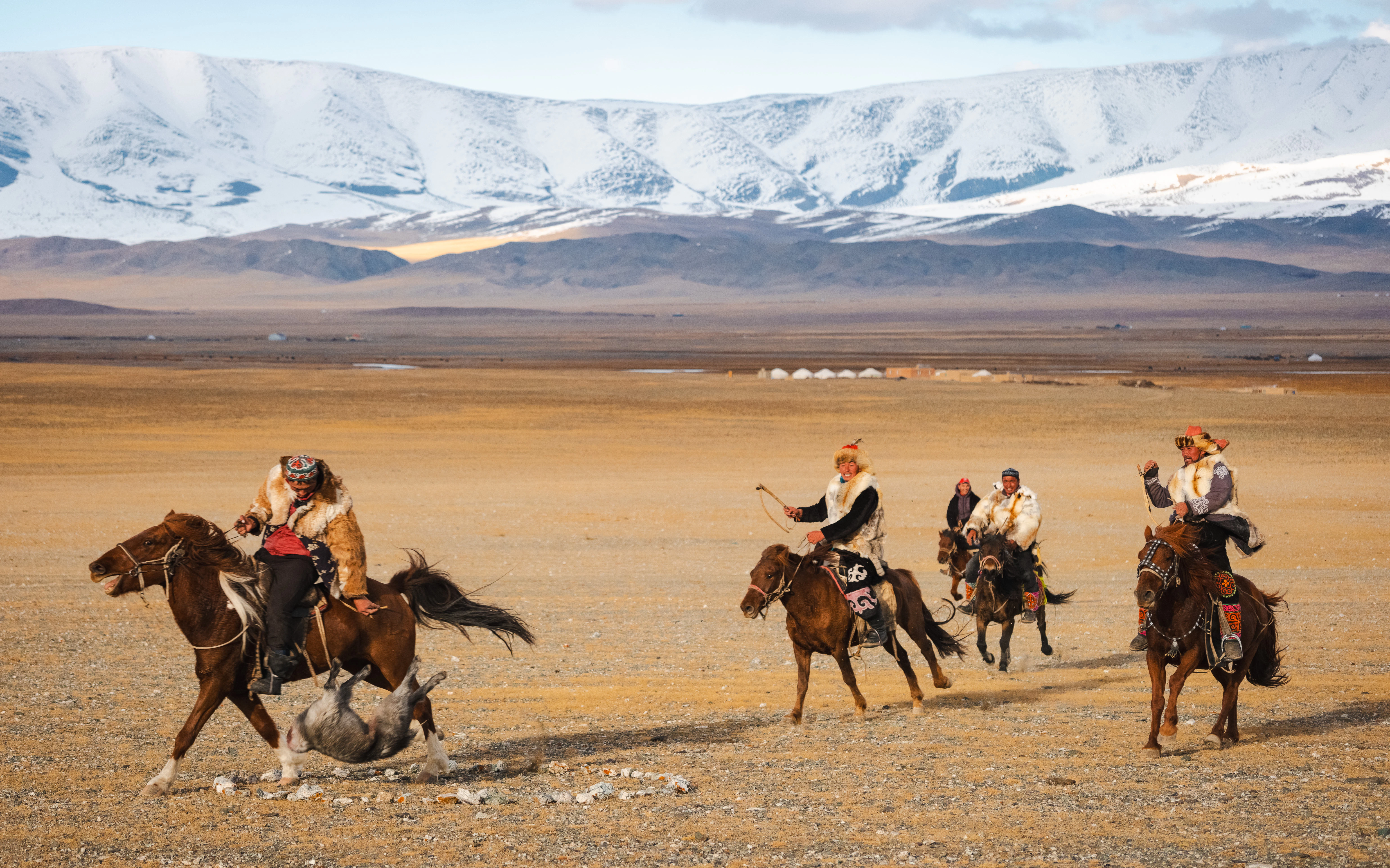 A group of people riding on the backs of horses