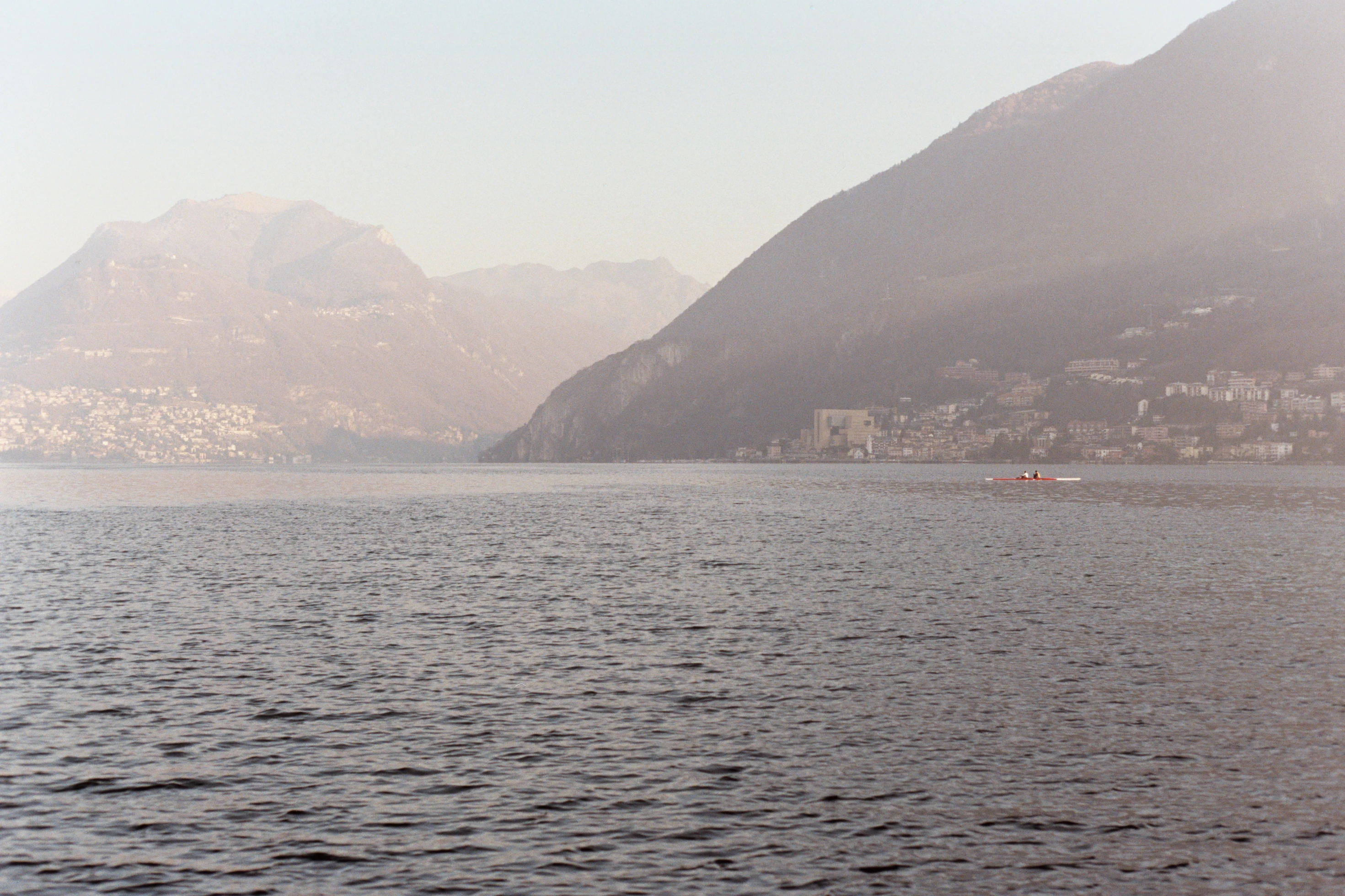 a body of water with mountains in the background