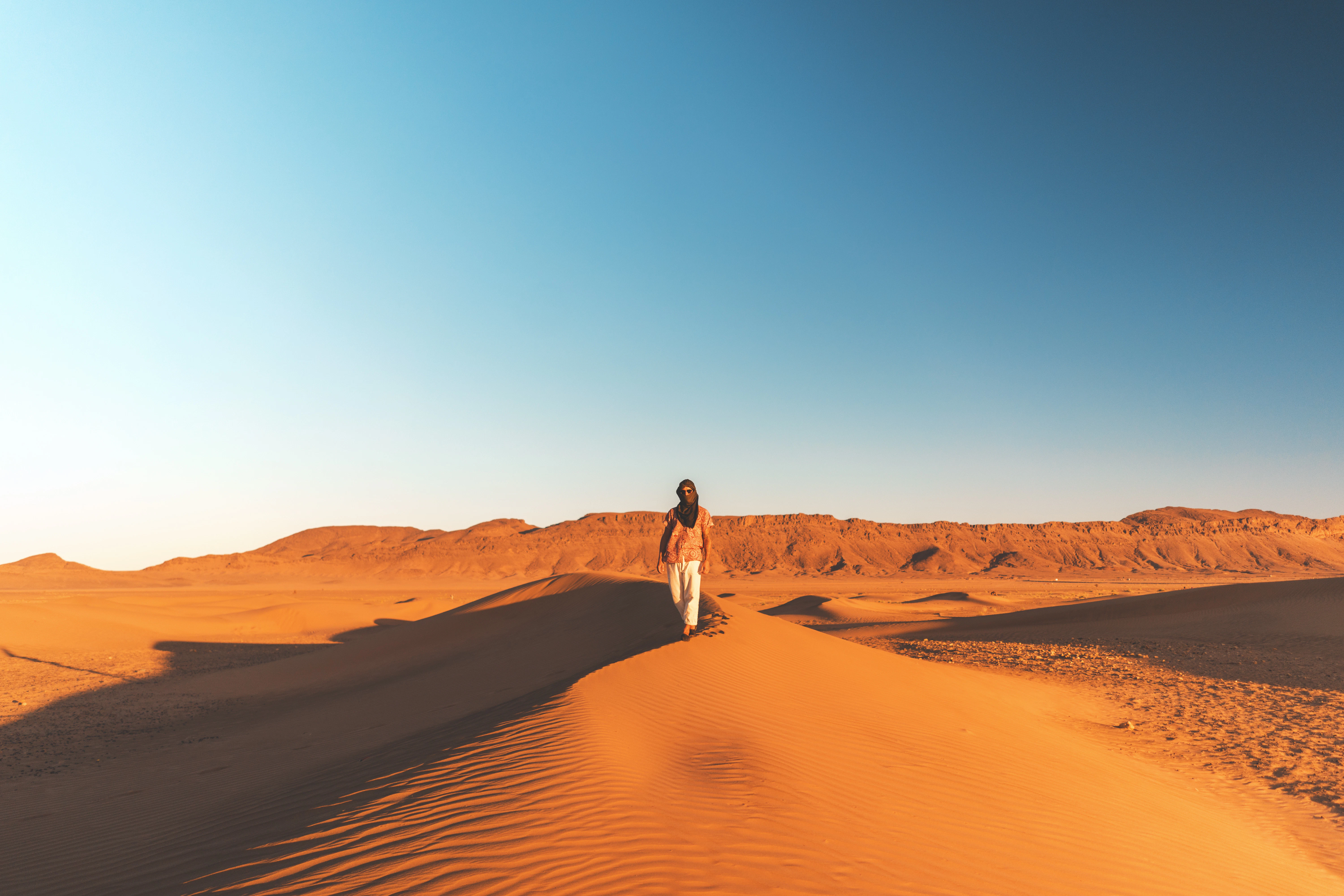 man walking on desert
