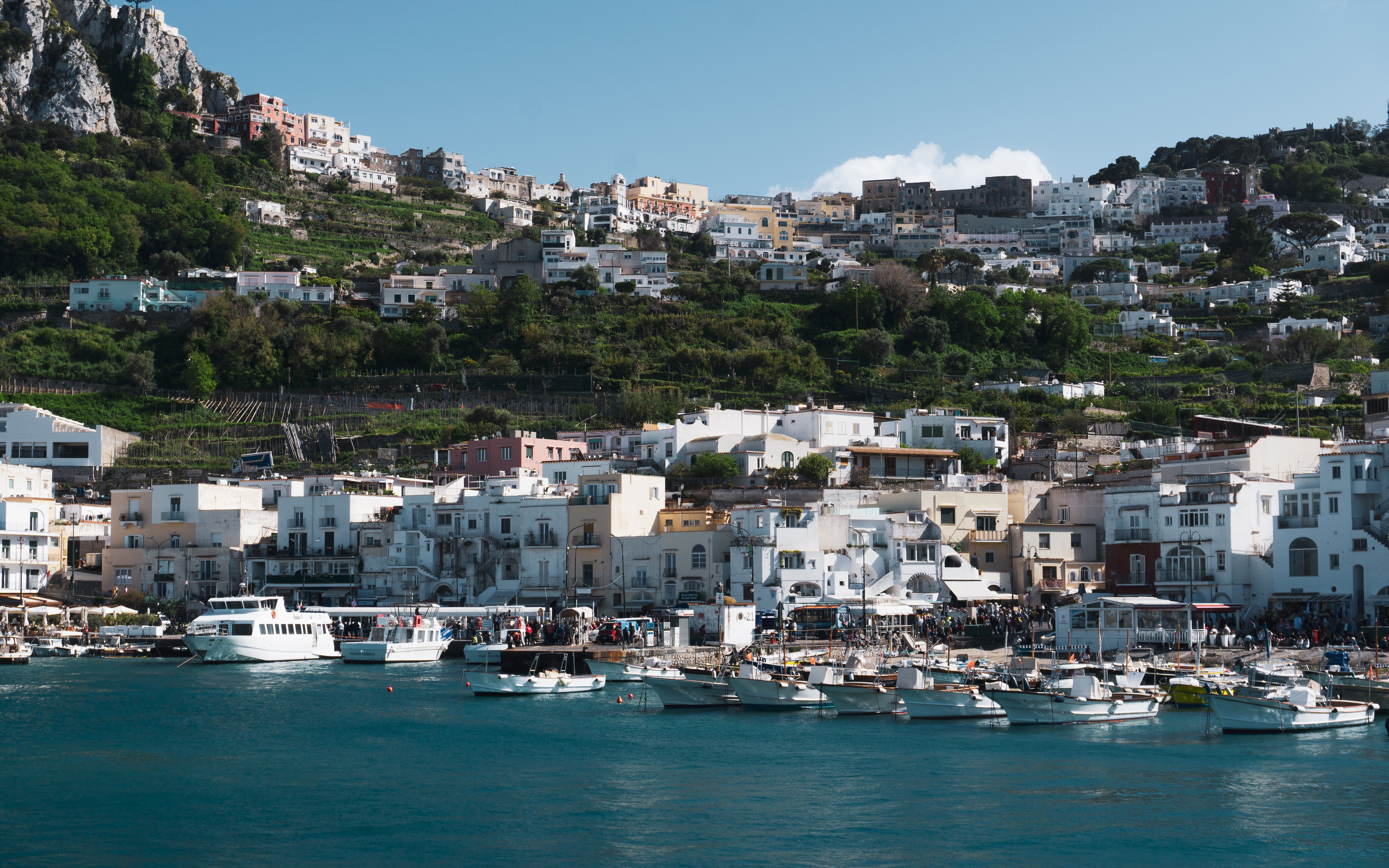 Coastal town with boats and buildings.