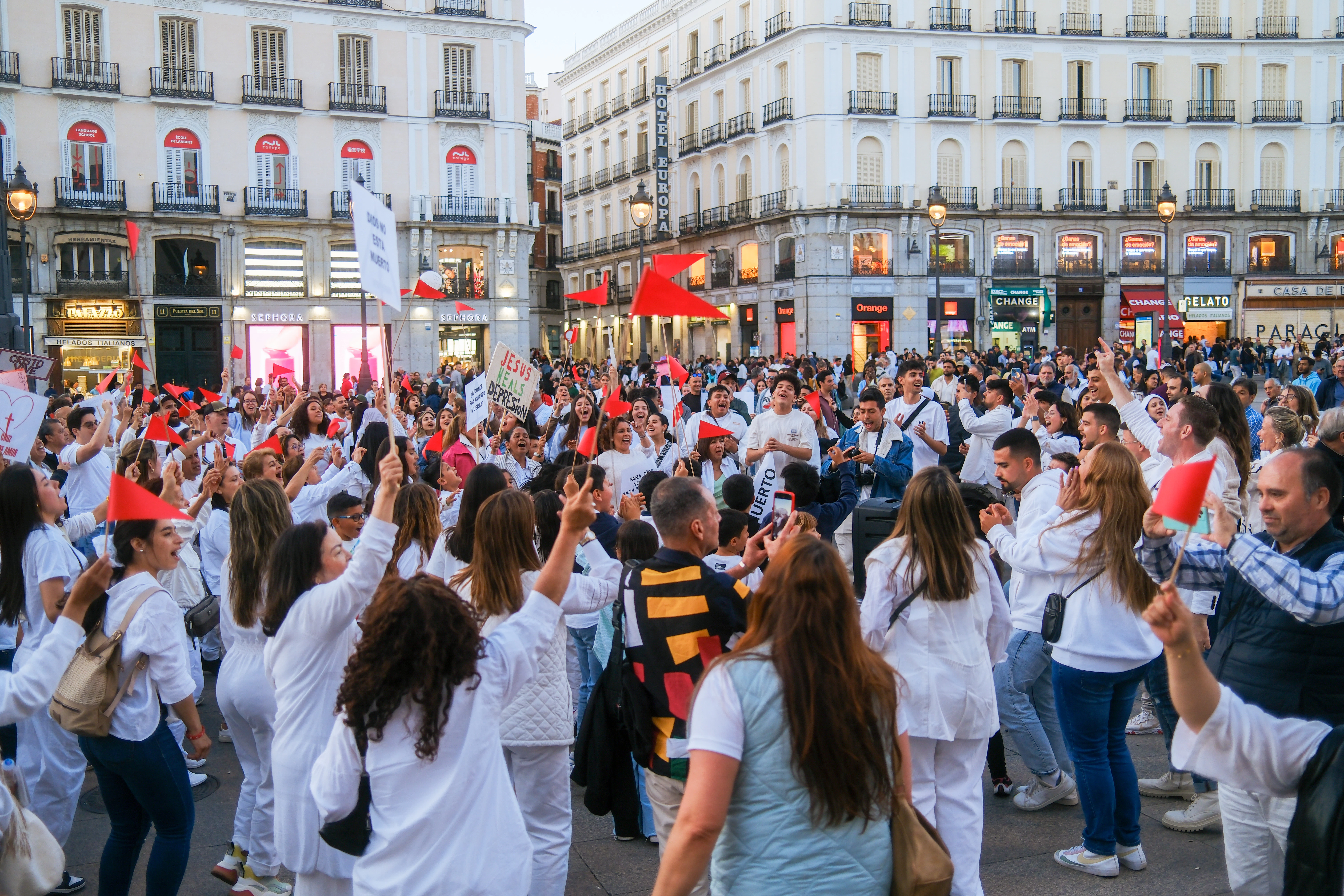 A large group of people walking down a street