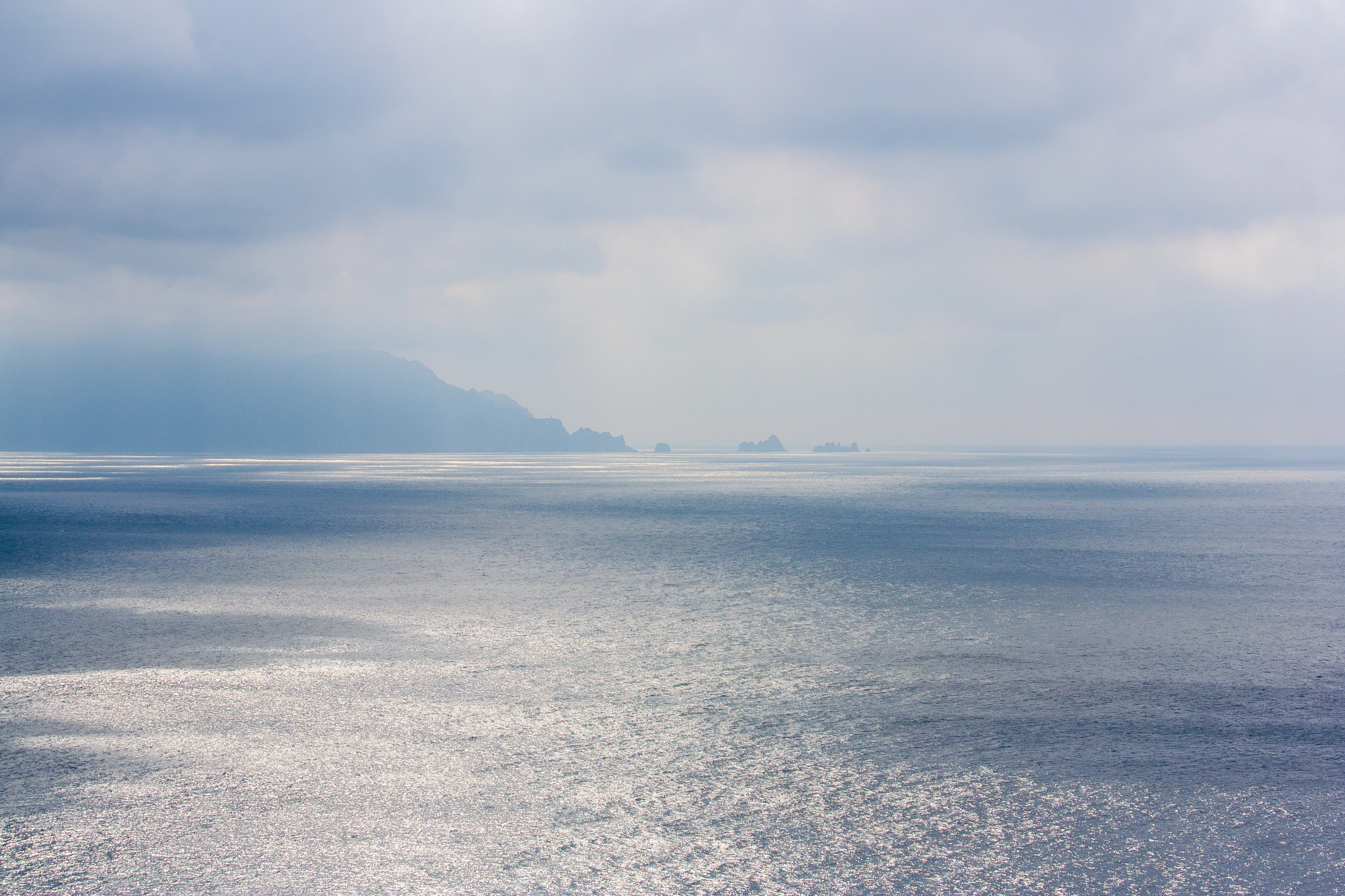 a large body of water under a cloudy sky