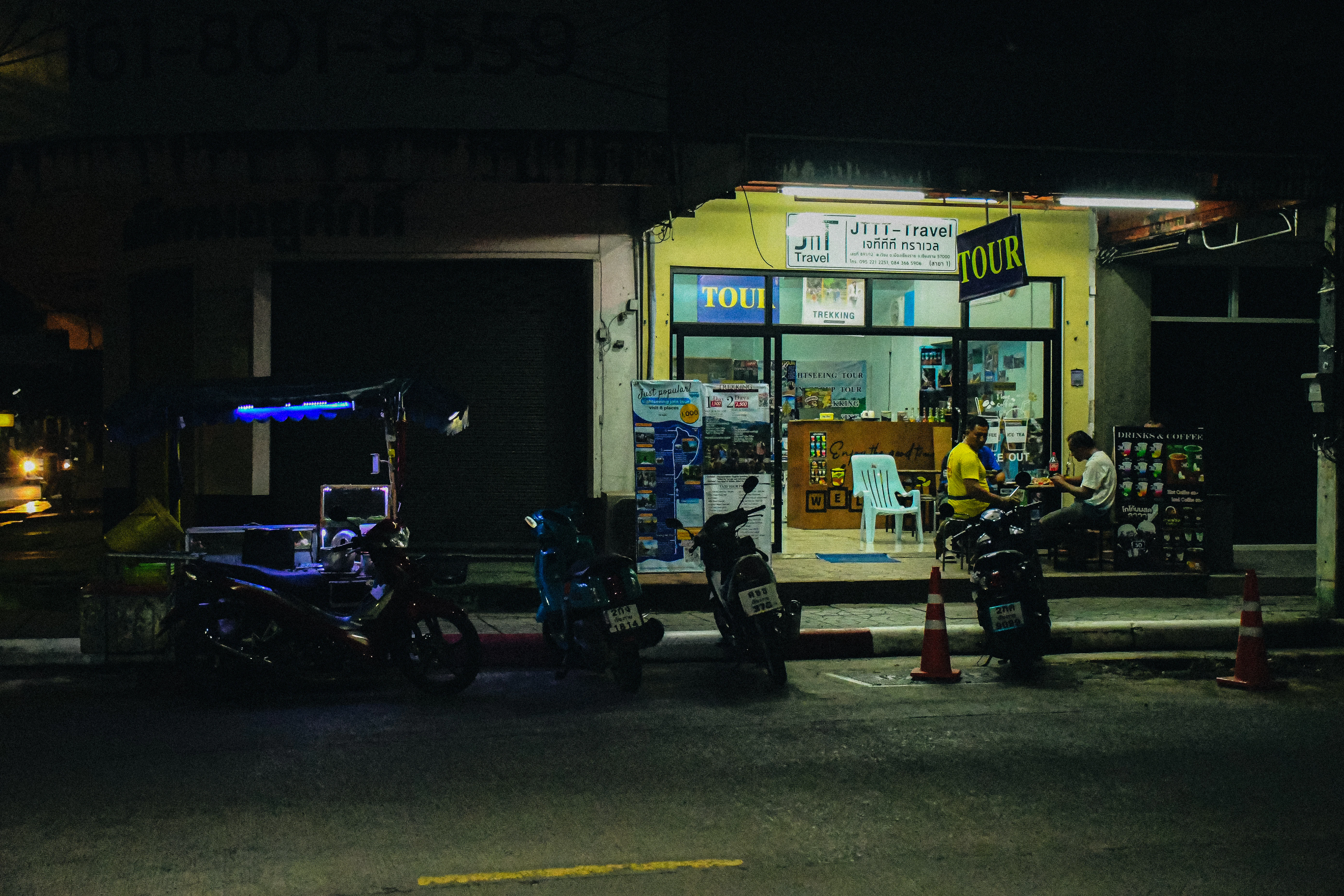 a couple of motorcycles parked in front of a store