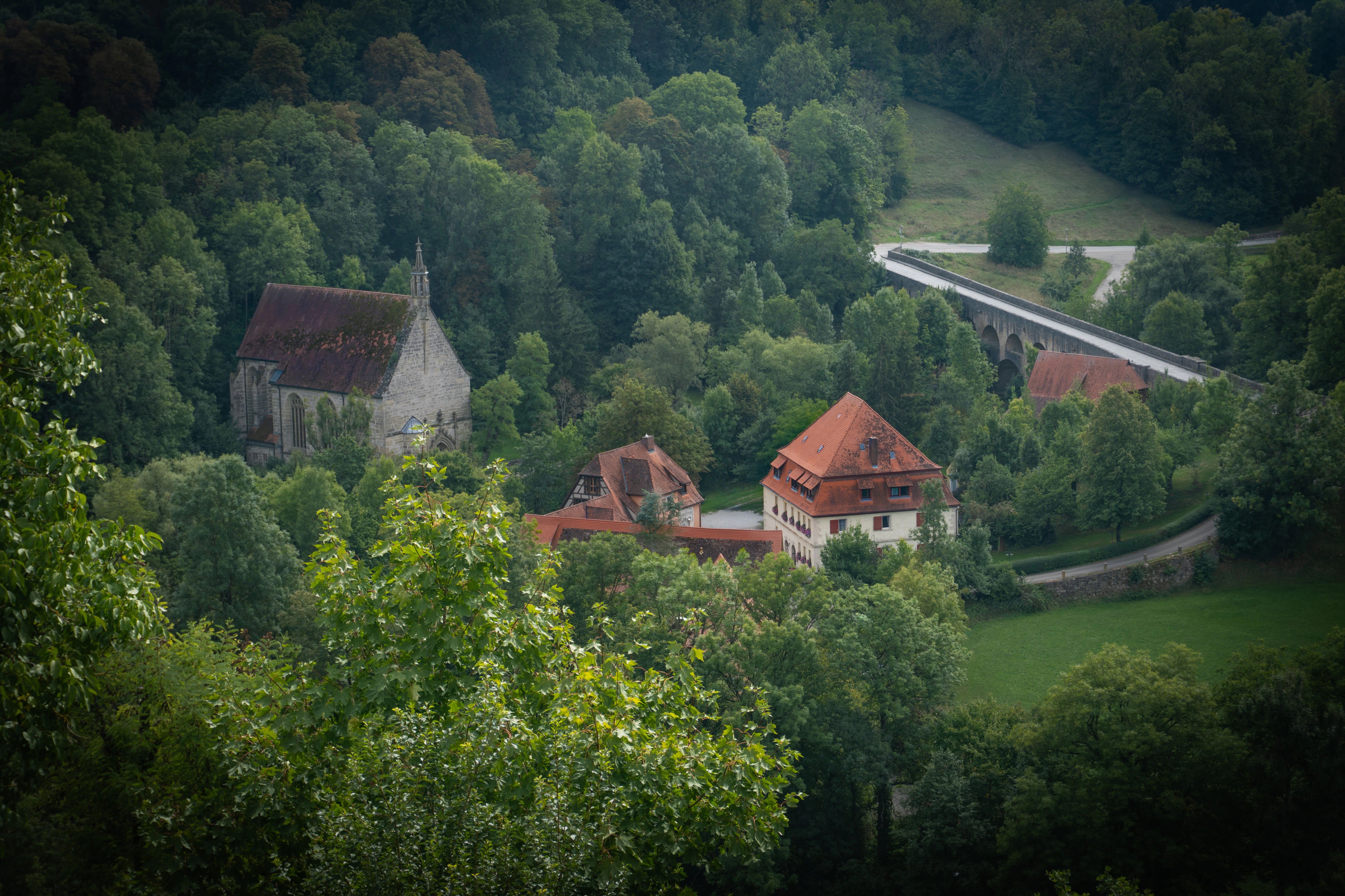an aerial view of a house surrounded by trees
