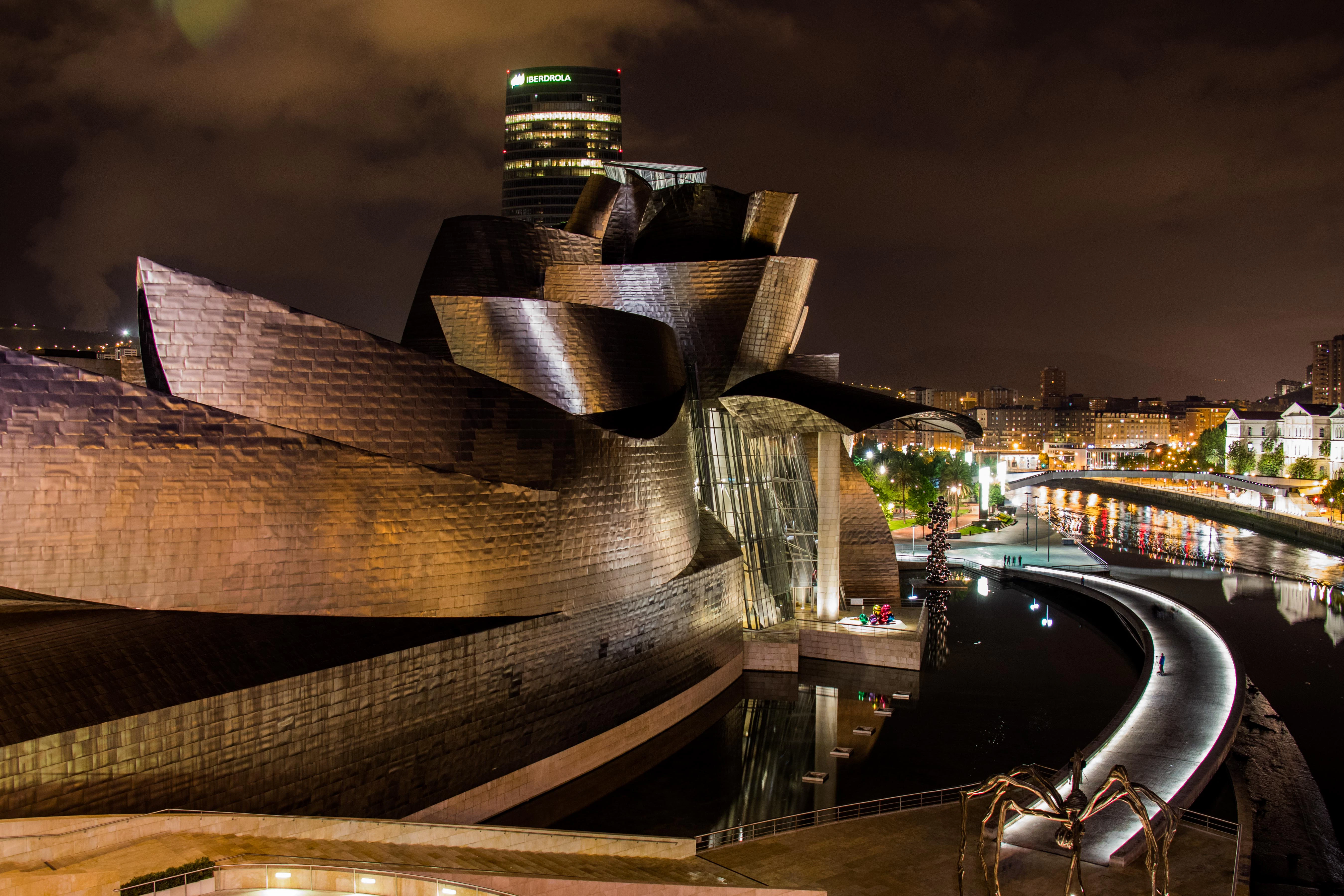 Guggenheim museum at night with reflections in water