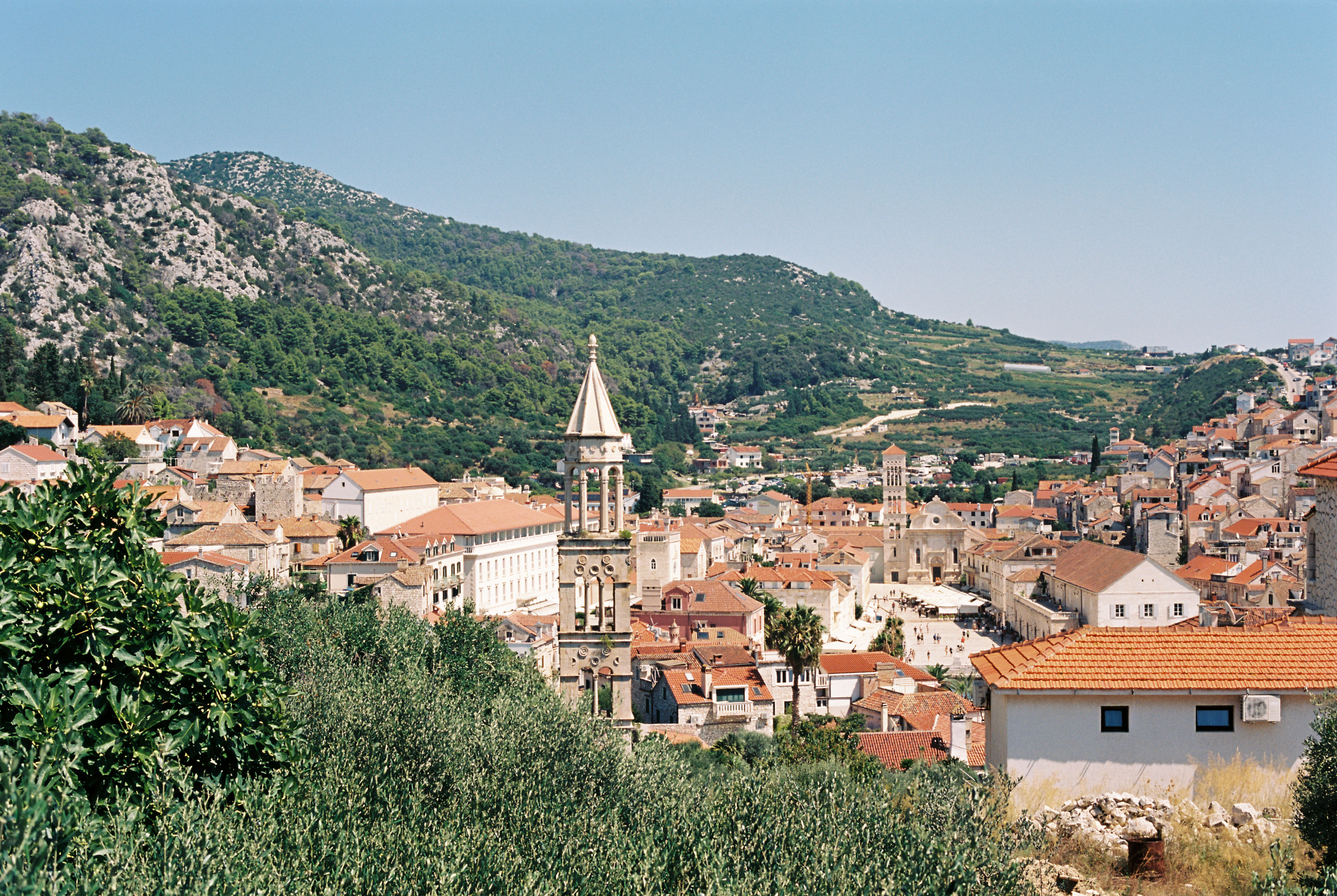 a view of a city with a steeple in the background