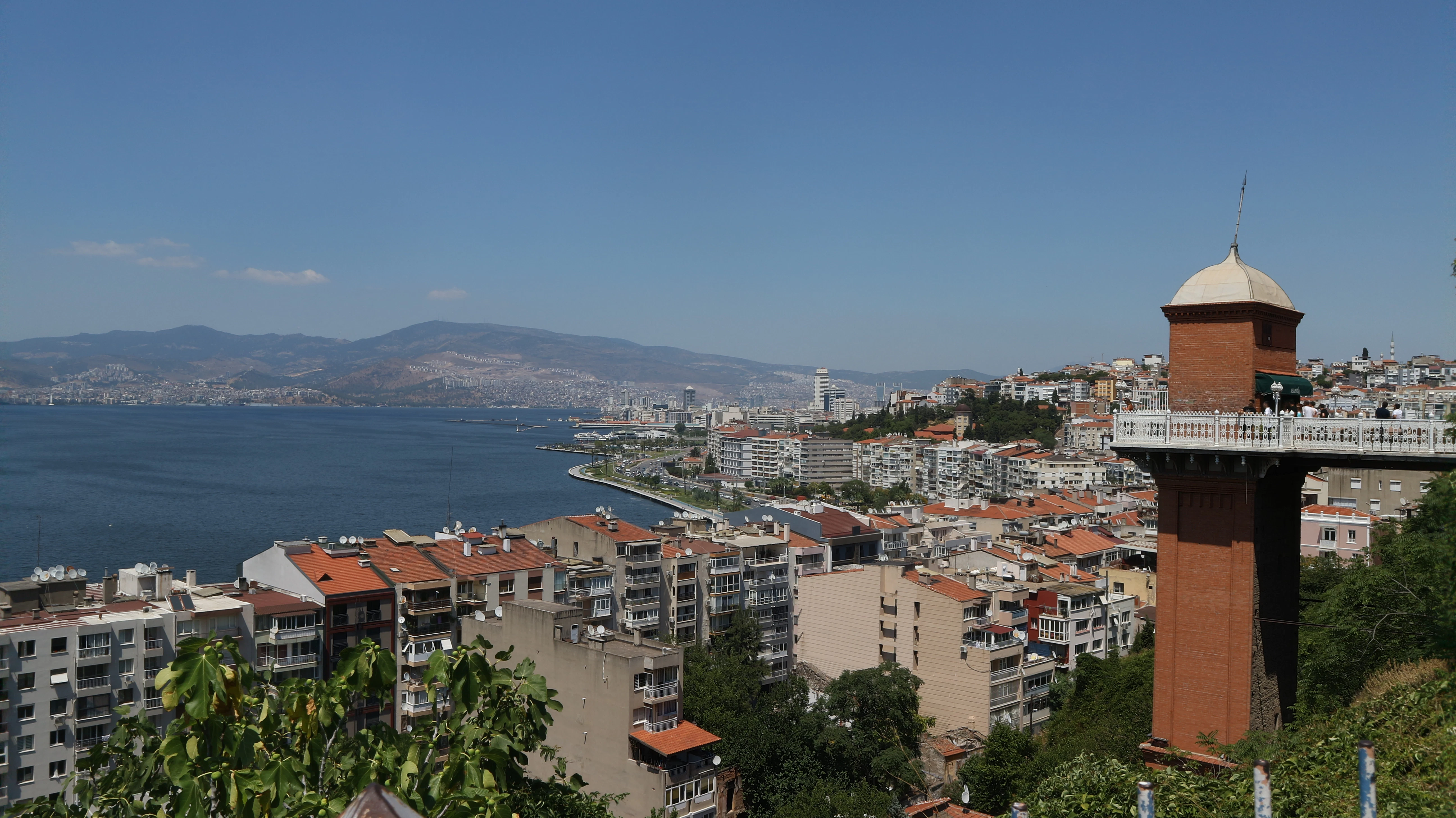 a city with a body of water in the background