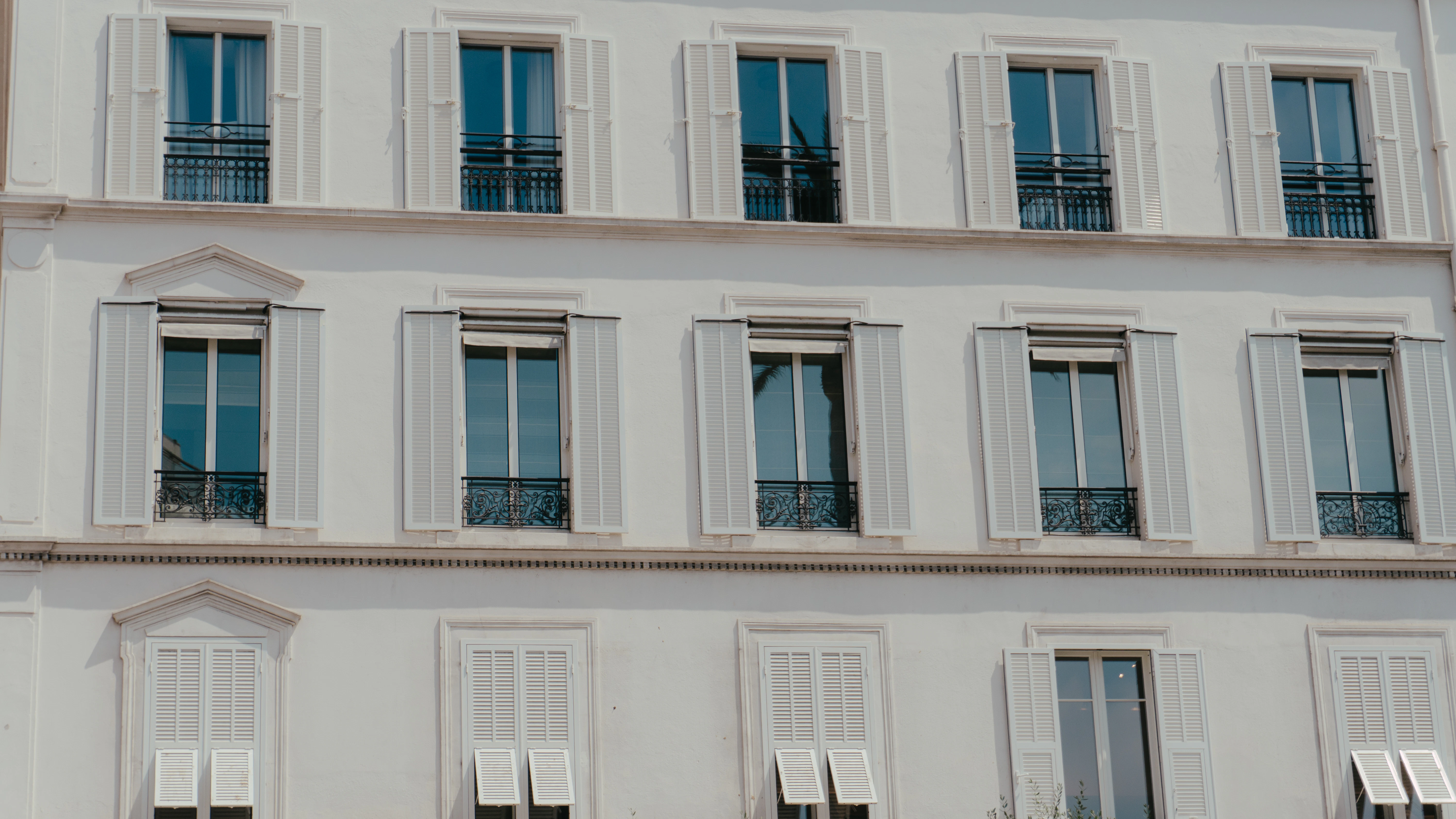 A white building facade with multiple windows.