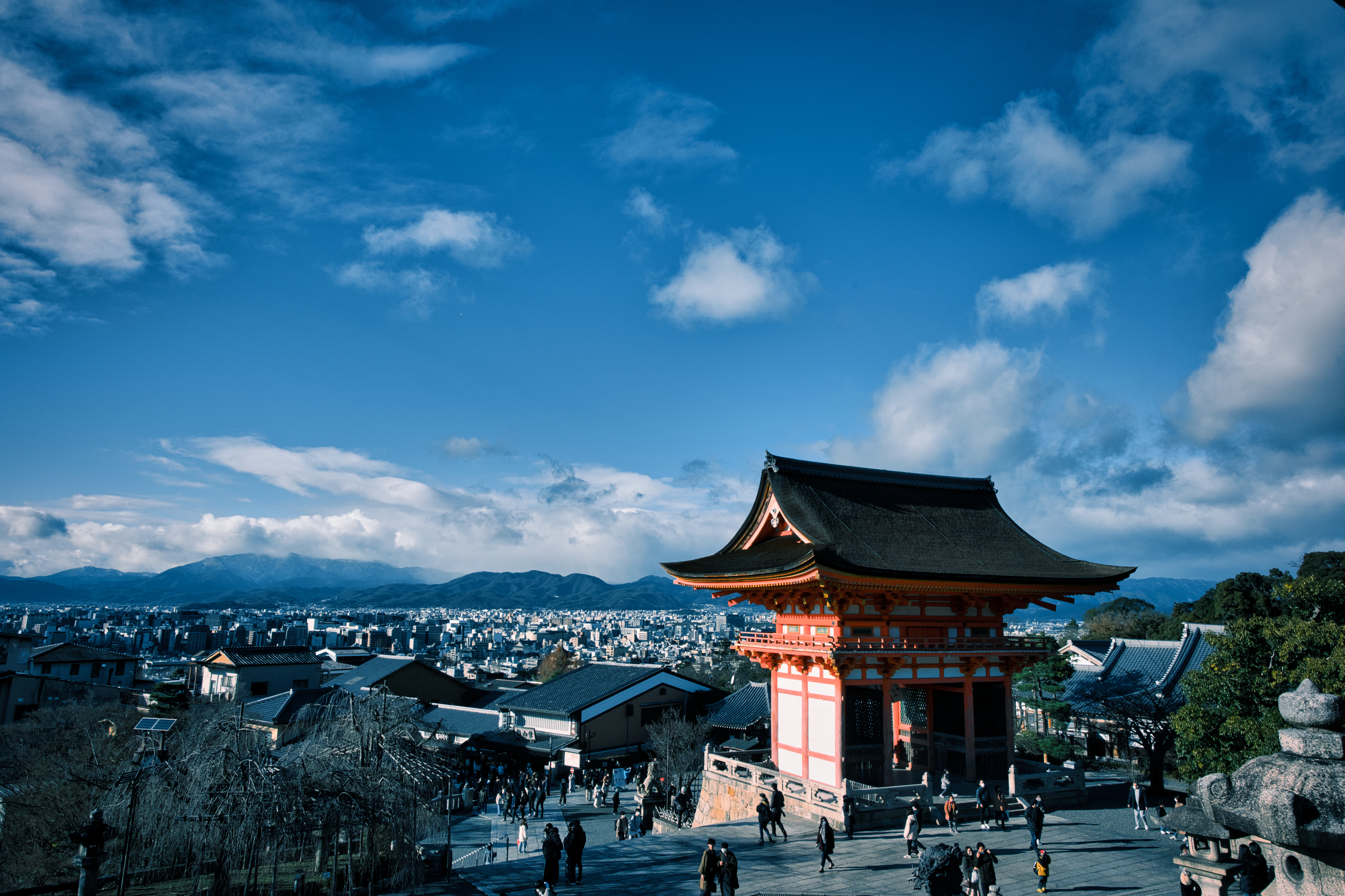 people walking around in front of a pagoda