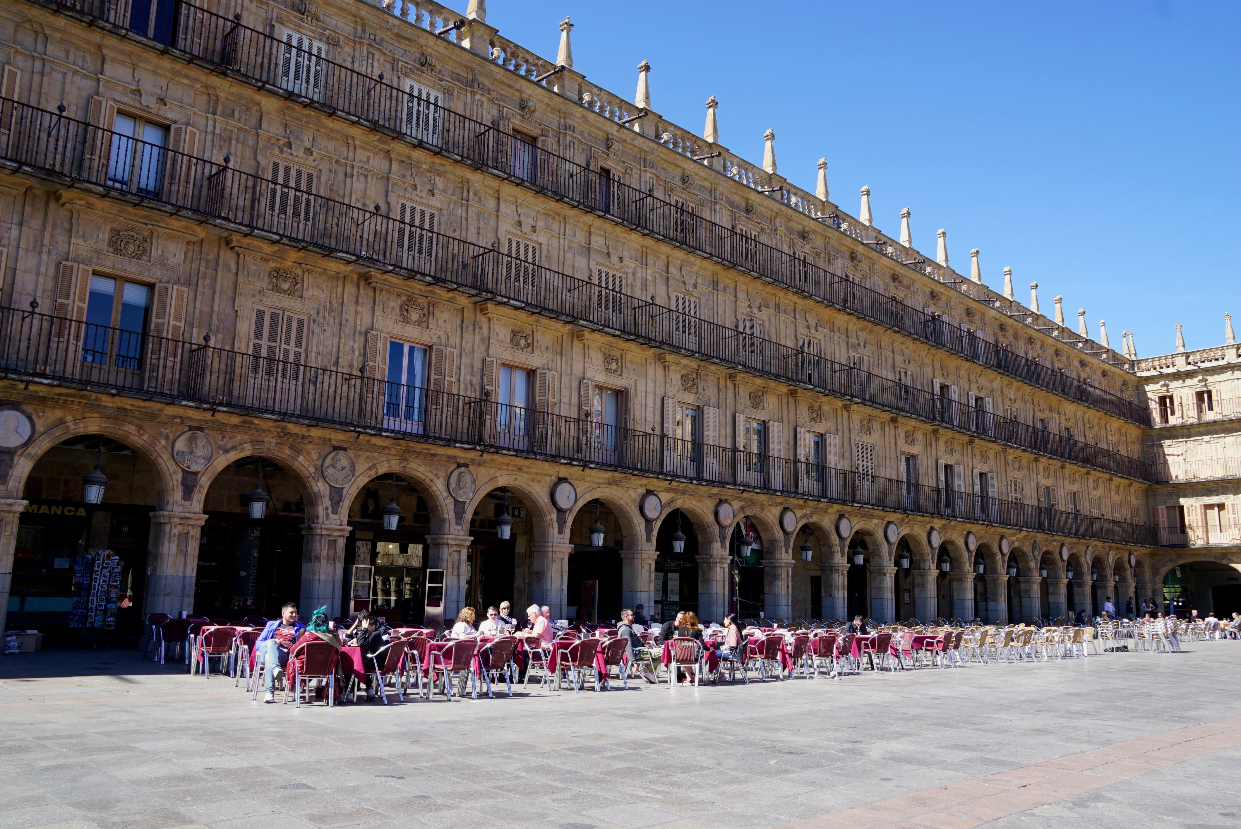 people in front of brown concrete building during daytime