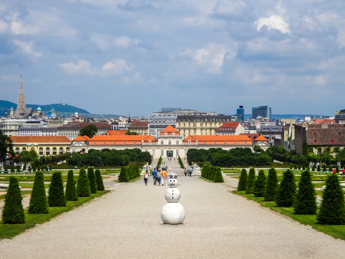 Grand palace gardens with a distant city skyline.