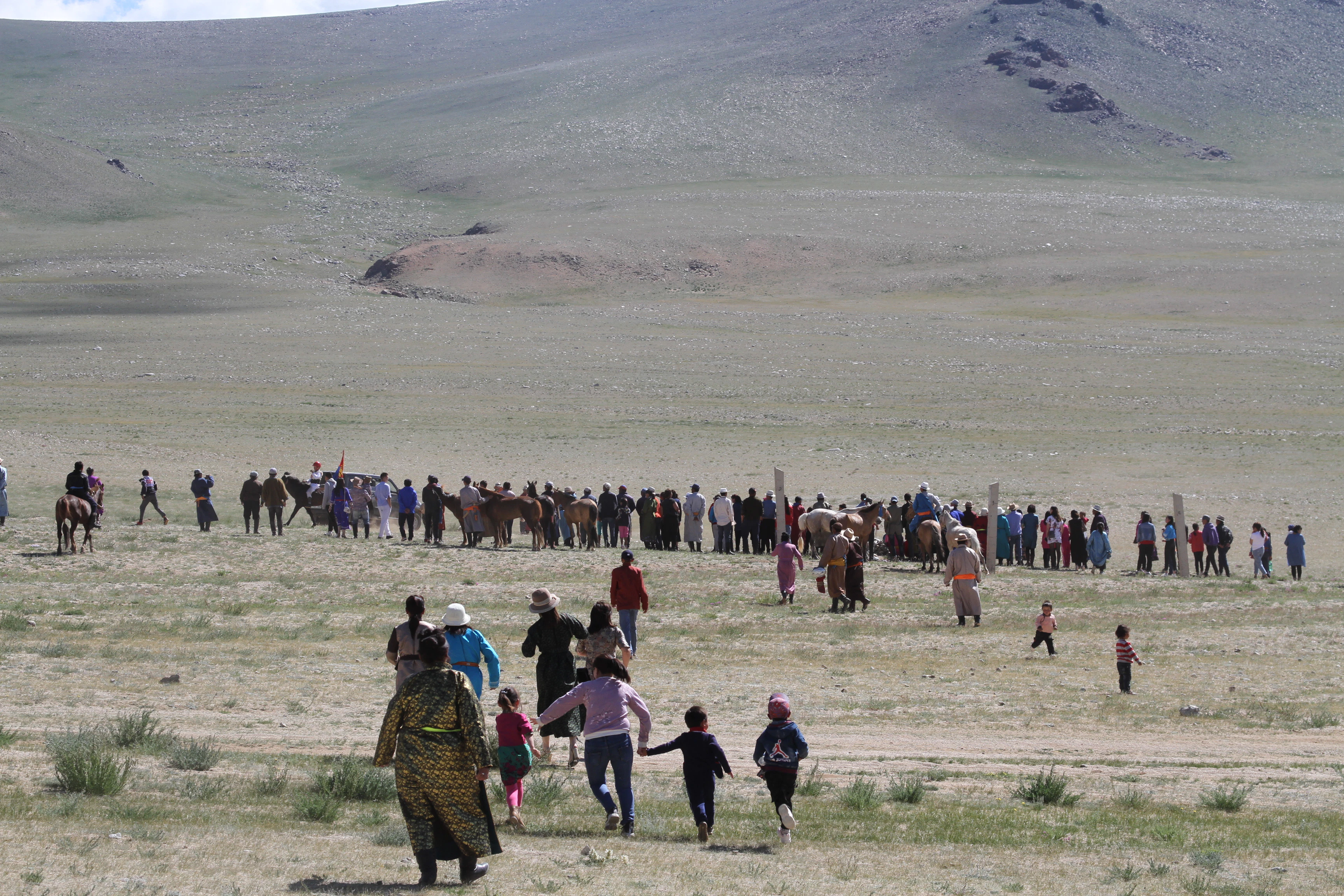 people standing on brown field during daytime