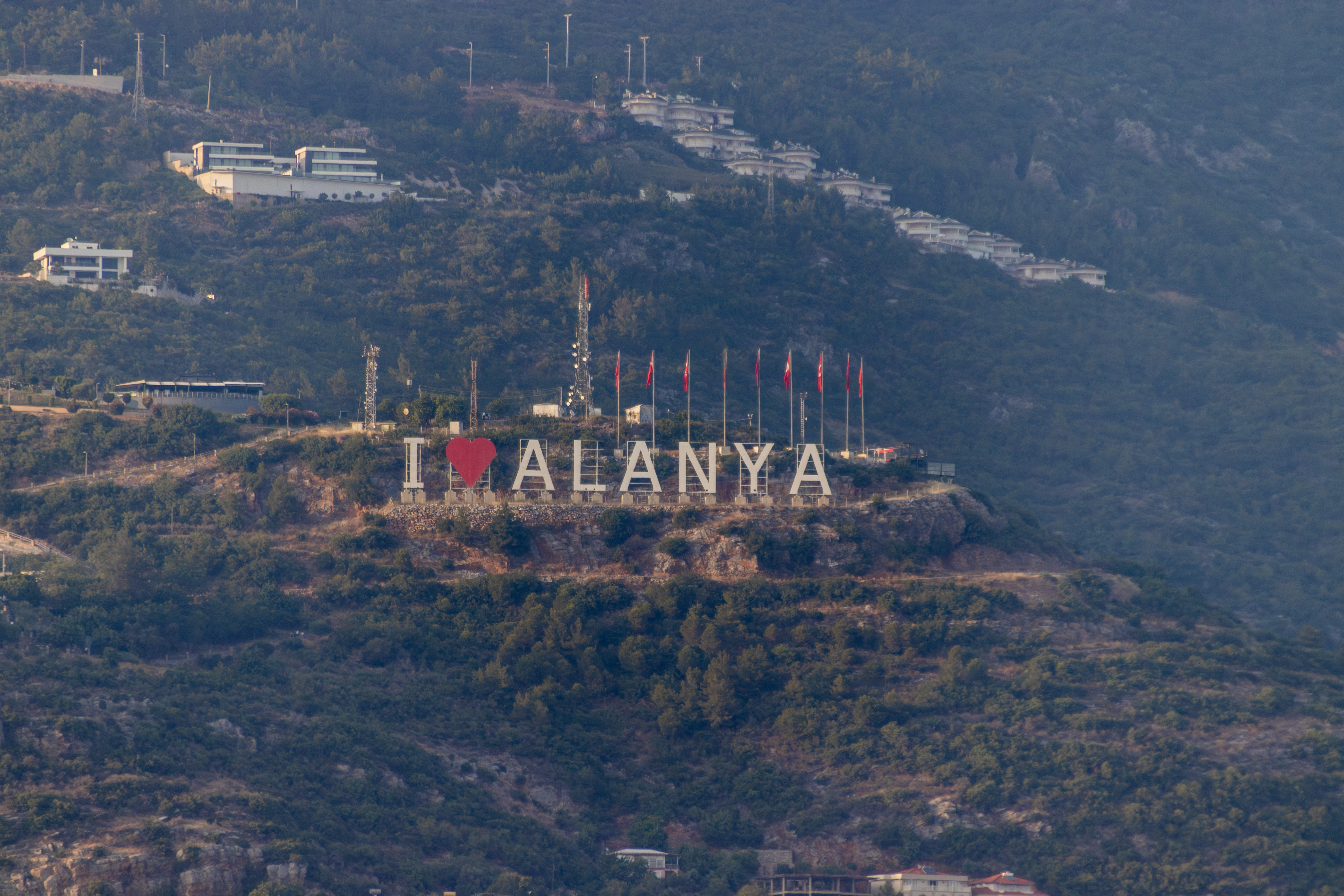 The "i love alanya" sign is on a hill.